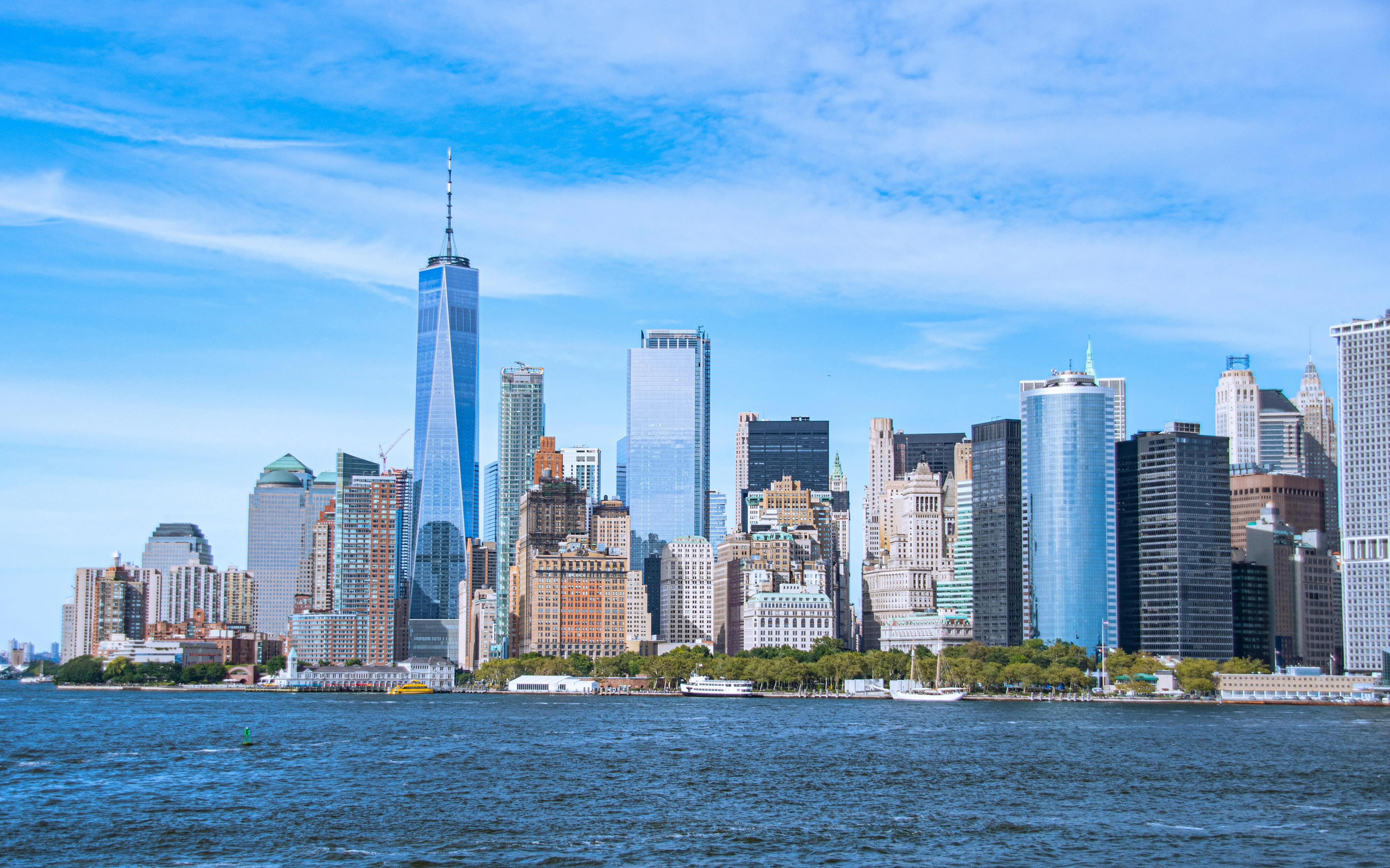 a city skyline with a body of water in the foreground