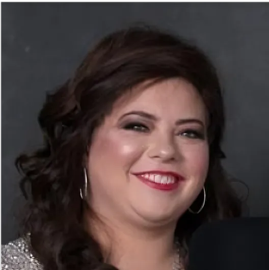 a woman with long hair smiling